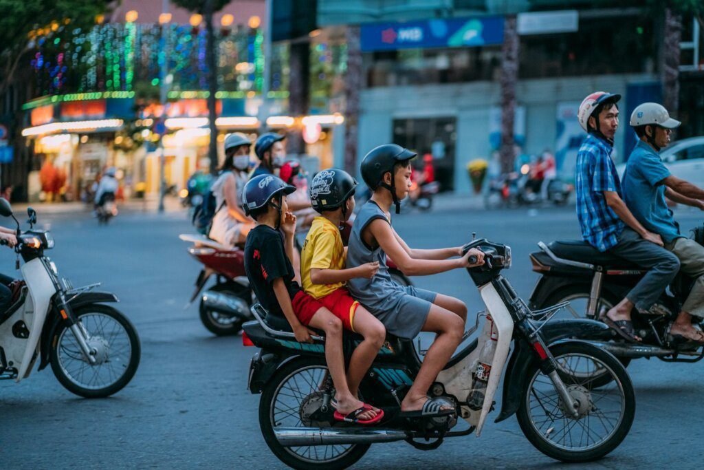 man in yellow shirt riding motorcycle with woman in yellow shirt